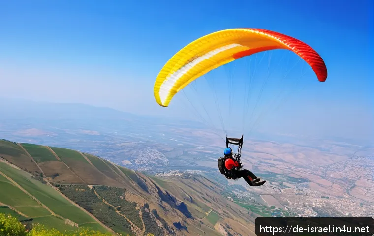 이스라엘에서 할 수 있는 익스트림 스포츠 - A dynamic scene of a paraglider soaring over the Hermon mountain range in Israel during spring, with...